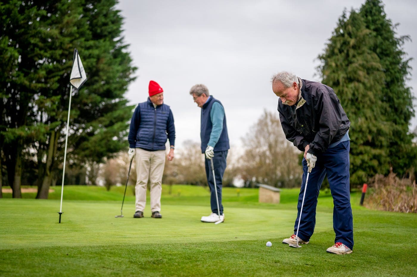 Golfers playing a round on a UK parkland course