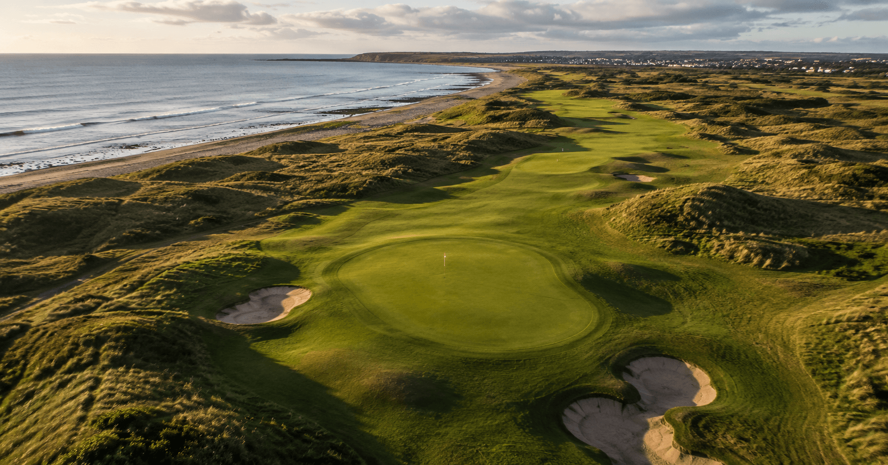 Aerial view of a links golf course beside the sea, UK